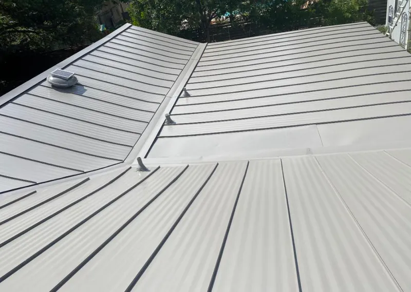 Solar attic fan installed on a metal roof for Roof Ventilation in Fort Payne