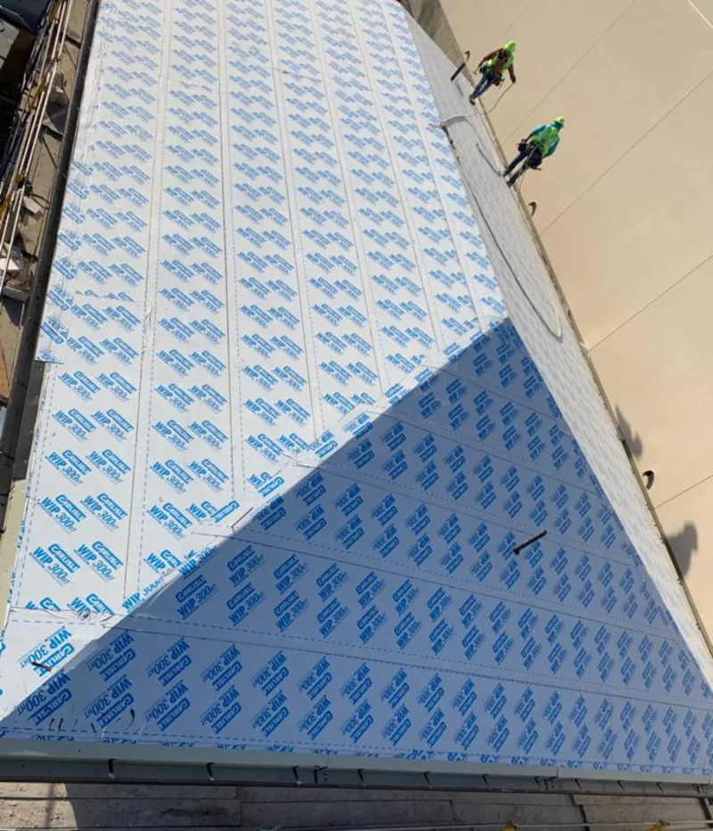 Professional roofers installing underlayment on a metal roof in Fort Payne